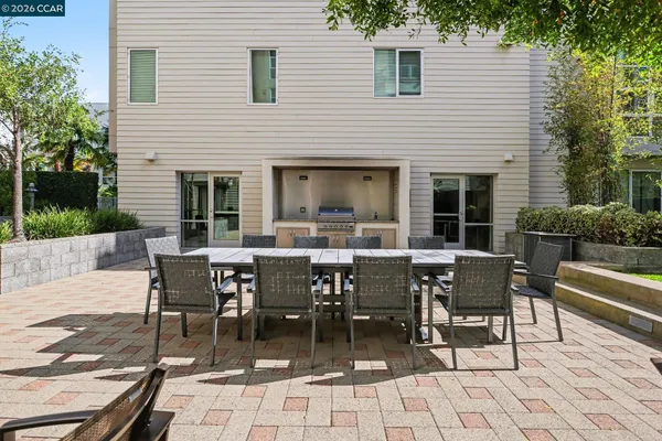 a view of a house with patio and a yard