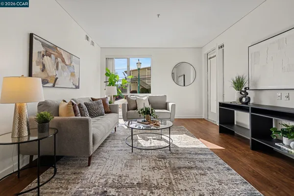 a living room with furniture a rug and a window