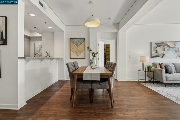 a view of a dining room with furniture and wooden floor
