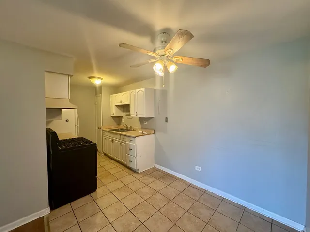 a kitchen with a refrigerator and a stove top oven
