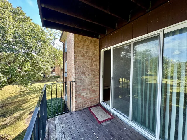 a view of a balcony with floor to ceiling window wooden floor and outdoor space