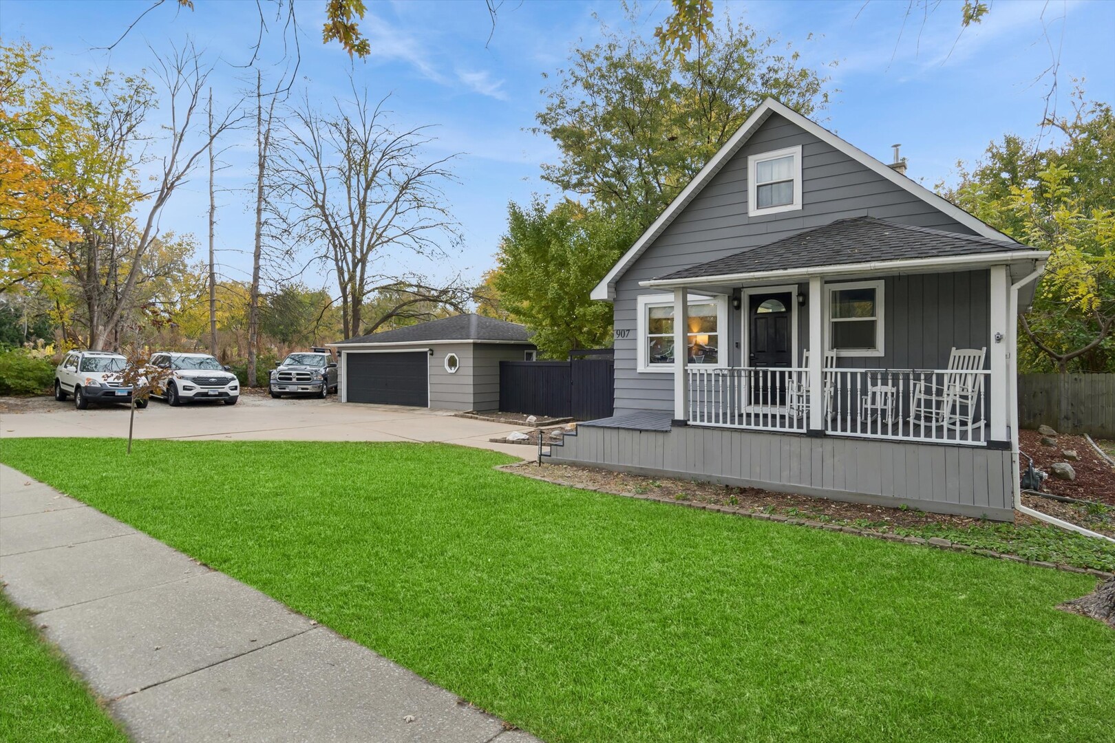 a view of a house with a yard and sitting area