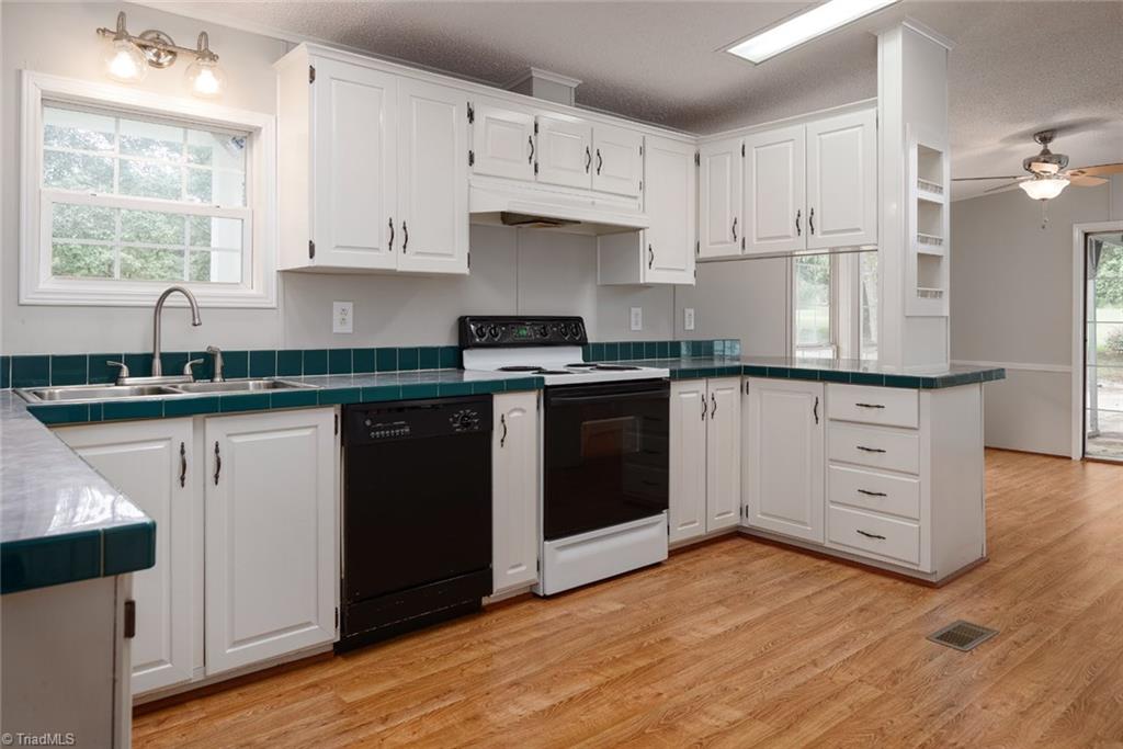 411 Apple Road Reidsville, NC 27320 - Photo 7 of 48 Roomy Kitchen with updated fixtures, built-ins and plenty of cabinet space
