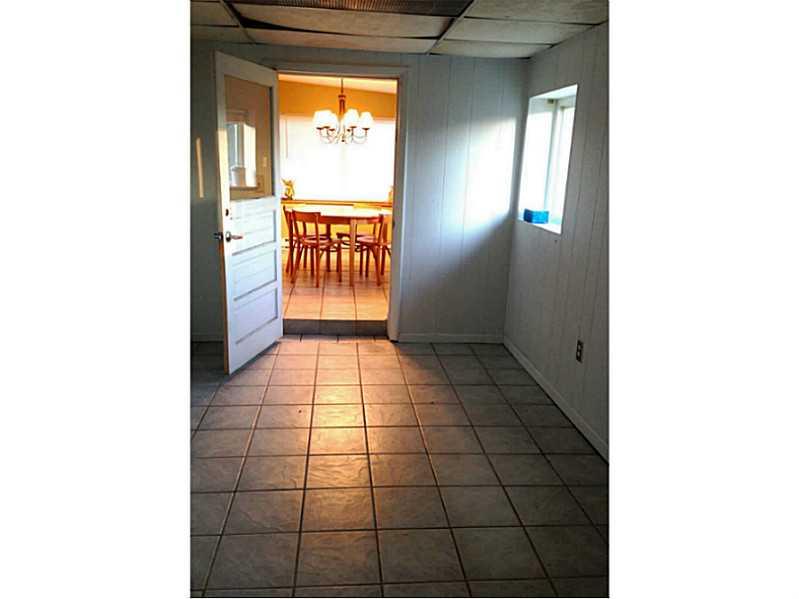 Den. This room is off of the dining room and could be main floor laundry, office, playroom, sun room, etc.