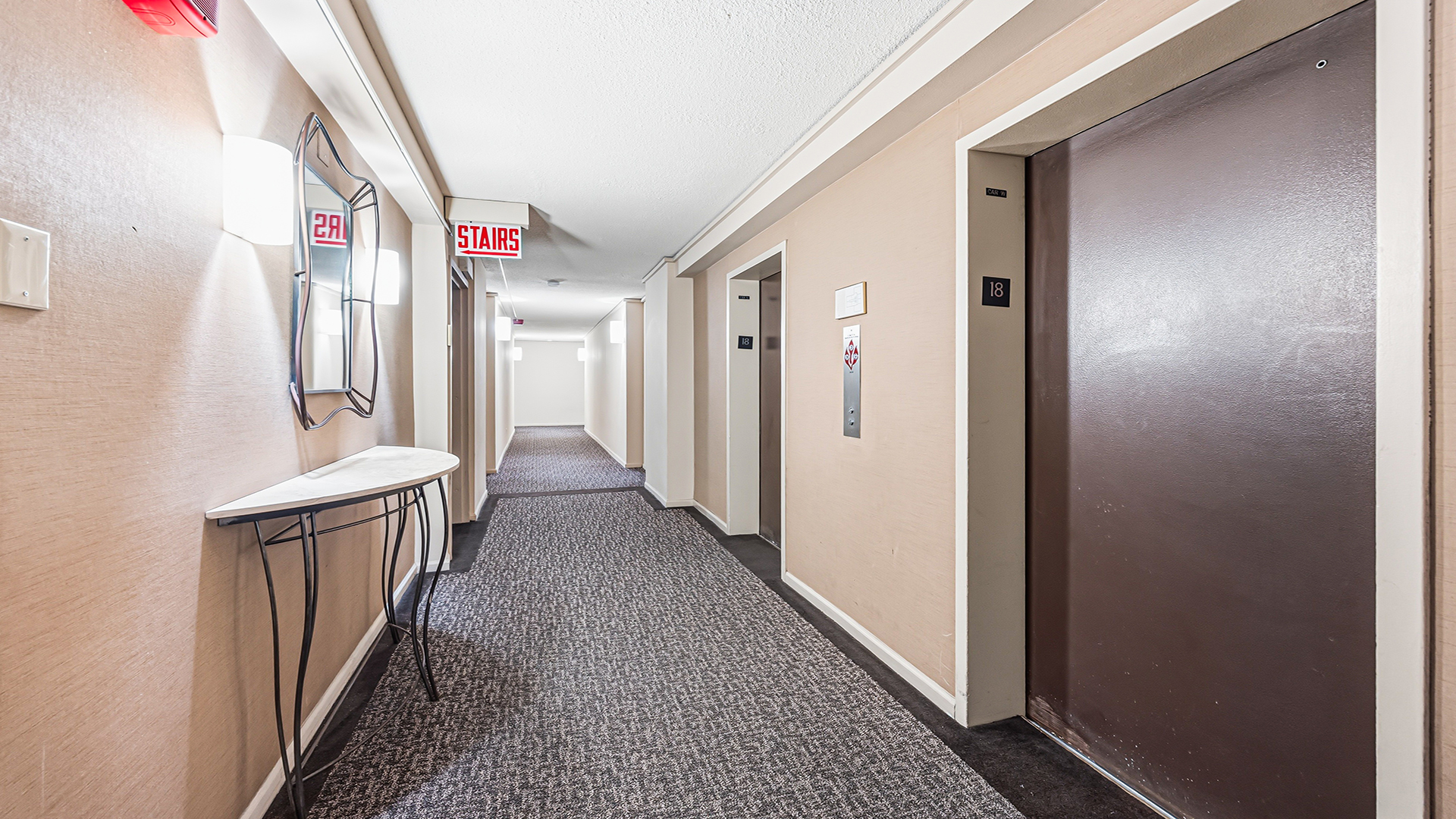 3110 North Sheridan Road, Unit 1807 Chicago, IL 60657 - Photo 4 of 21 a view of a hallway with white walls and stairs