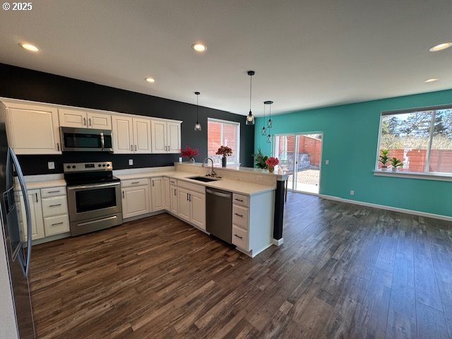 1966 34th Street Florence, OR 97439 - Photo 20 of 30 a kitchen with a sink wooden floor and stainless steel appliances