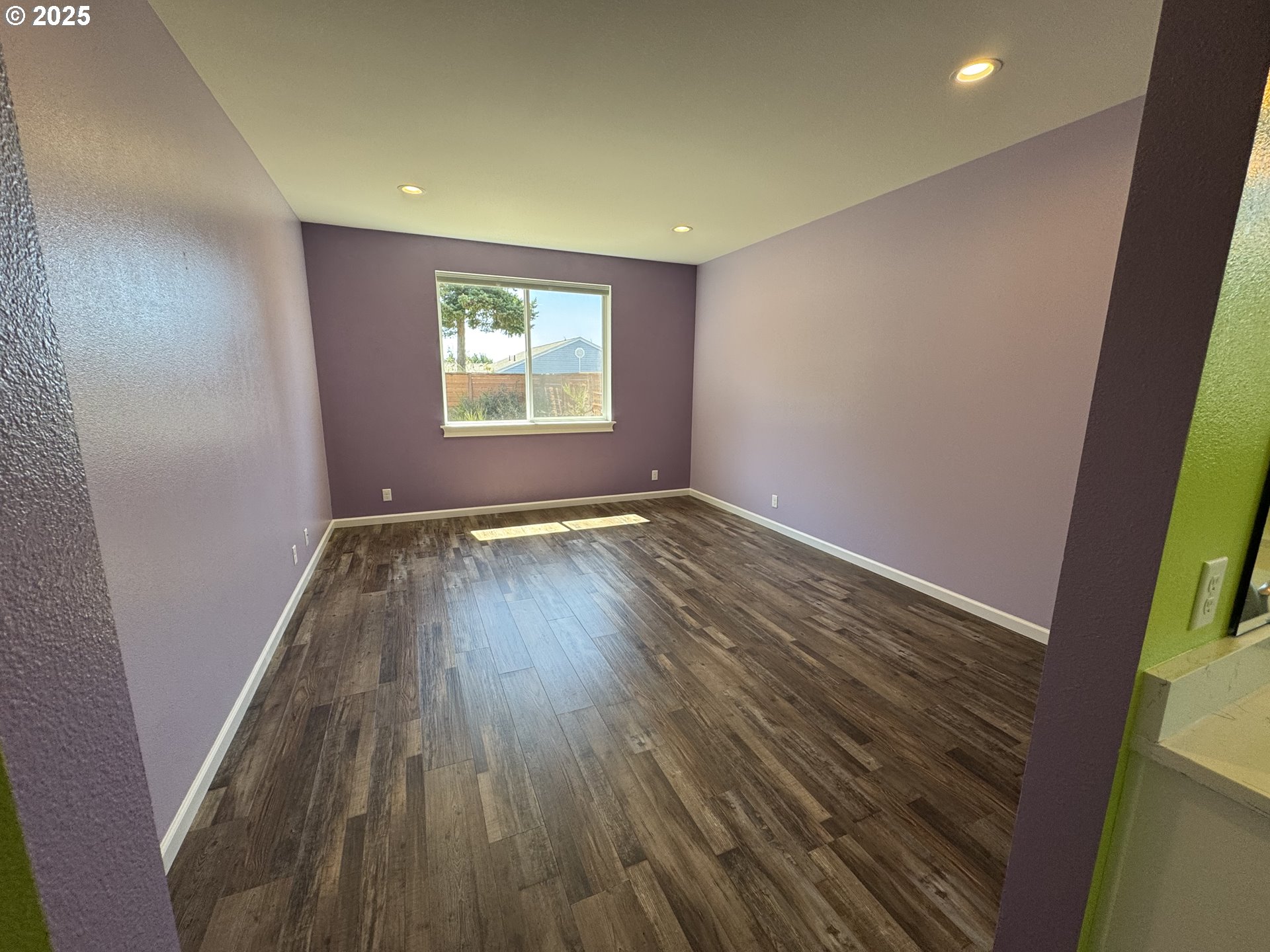 1966 34th Street Florence, OR 97439 - Photo 5 of 30 an empty room with wooden floor and windows