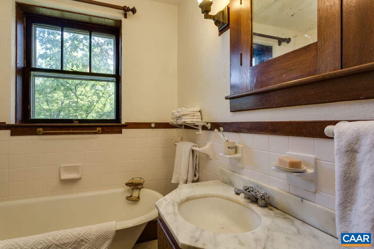 3211 Lowesville Road Roseland, VA 22967 - Photo 25 of 48 a bathroom with a granite countertop sink and a mirror