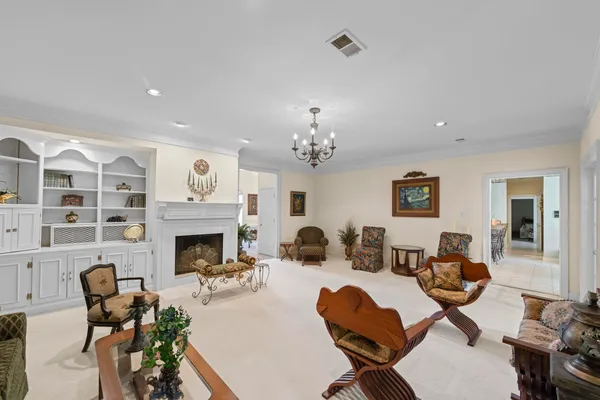 a living room with furniture or chandelier and a fireplace