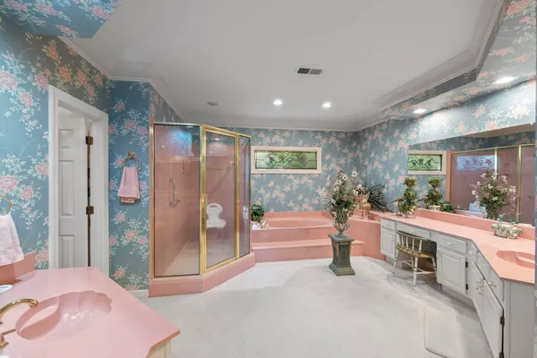 a large bedroom with a large bed and glass door