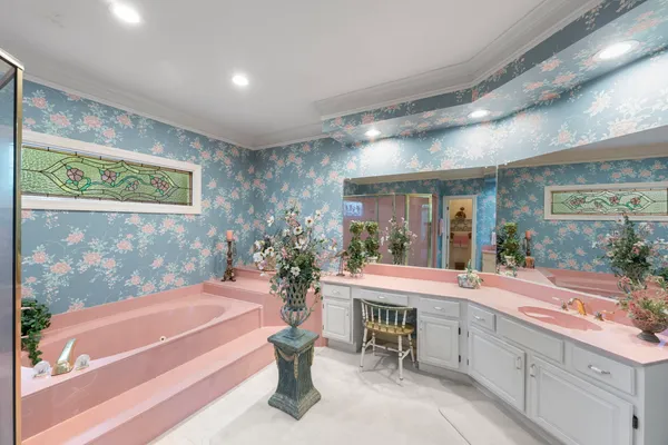 a living room with a large window and furniture