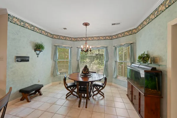a dining room with furniture and window
