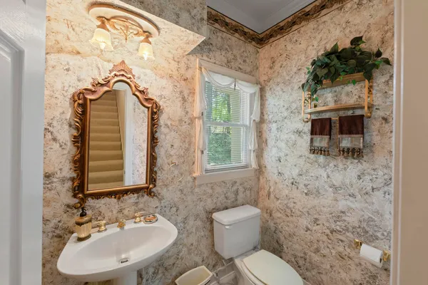 a bathroom with a sink toilet and mirror