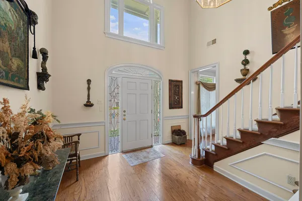 a view of entryway and hall with wooden floor