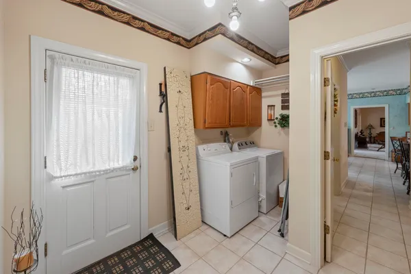a utility room with cabinets dryer and washer