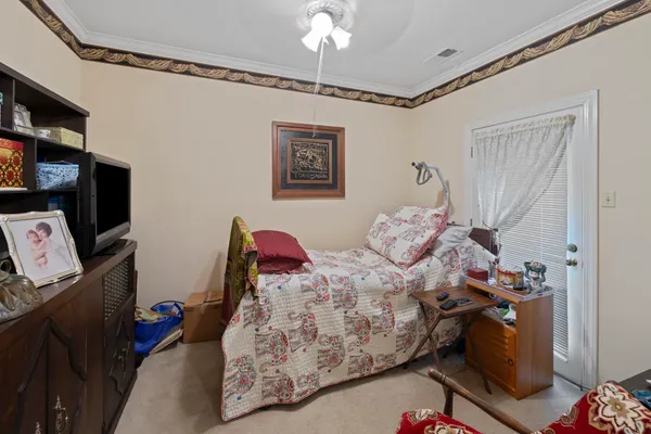 a bed room with a bed and a computer on a desk