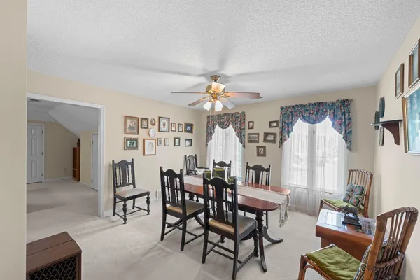 a view of a dining room with furniture and chandelier