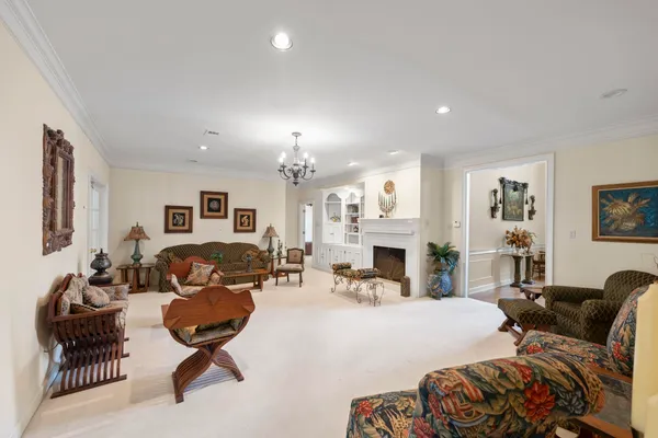 a living room with furniture kitchen view and a fireplace