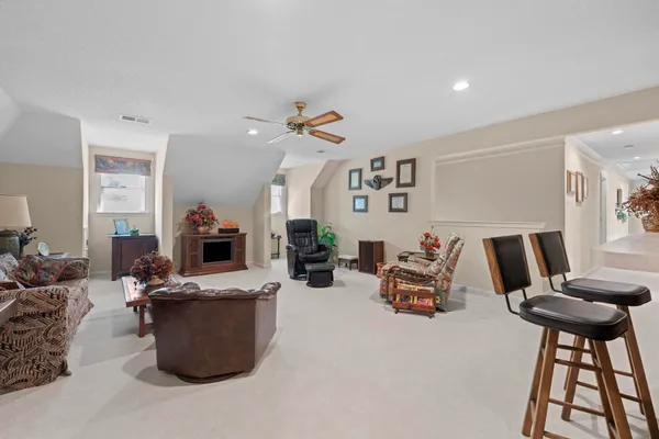 a living room with furniture a clock and a window