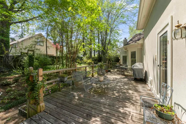 a backyard of a house with table and chairs