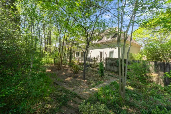 a backyard of a house with garden and trees