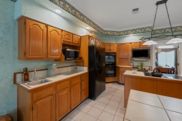 a kitchen with stainless steel appliances wooden cabinets a sink and a stove