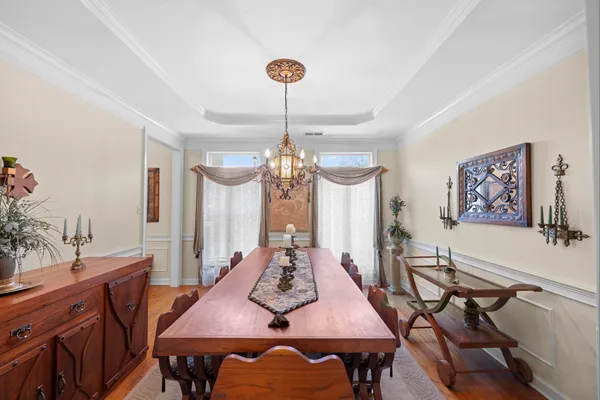 a view of a dining room with furniture and a chandelier
