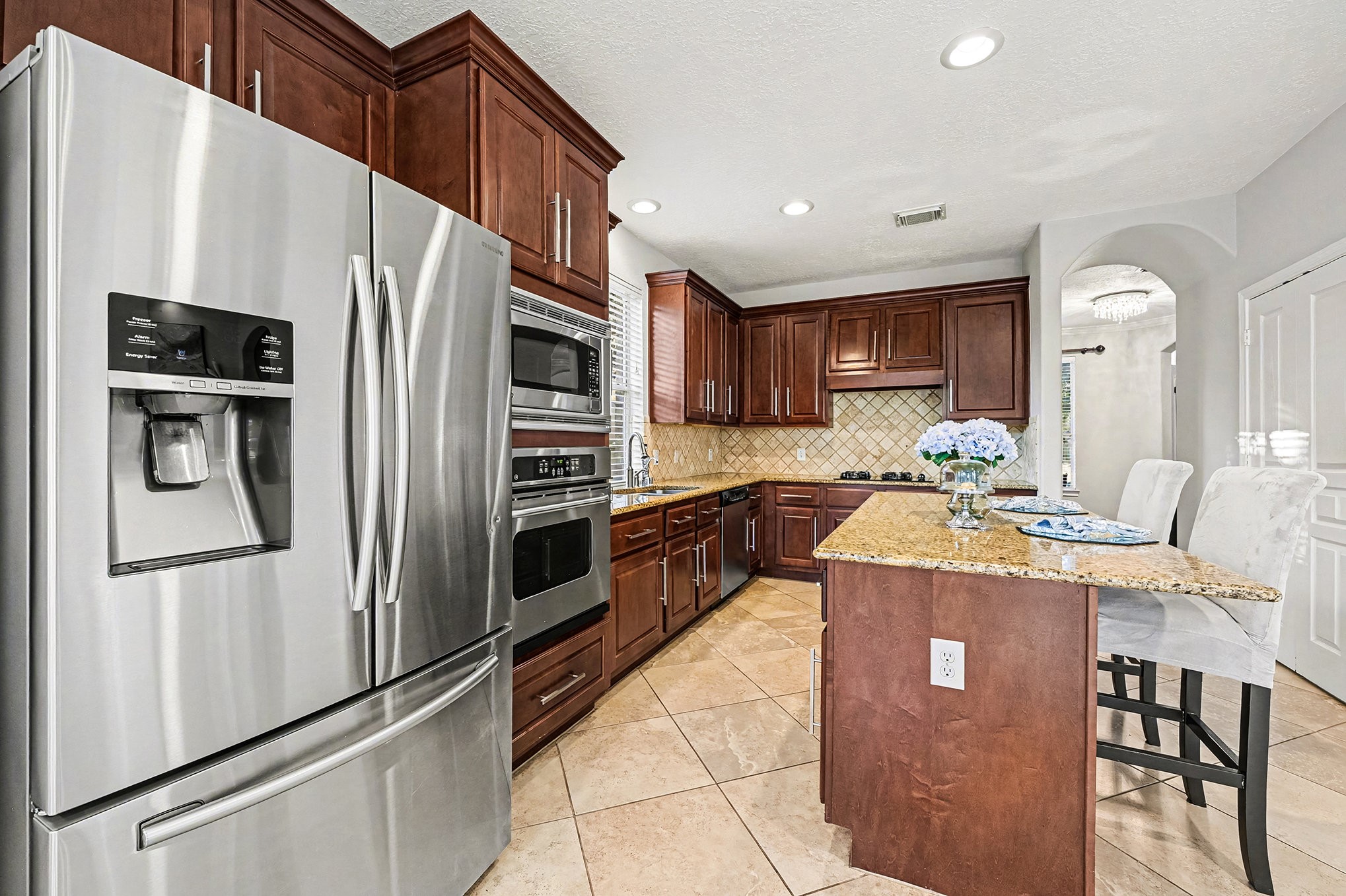 4402 Eden Point Lane Katy, TX 77494 - Photo 15 of 39 This is a chef's dream kitchen which features rich all wood cabinets by Kent Moore, stainless appliances, granite counters, island with seating and diagonally laid tile. Open to Family room and breakfast area.