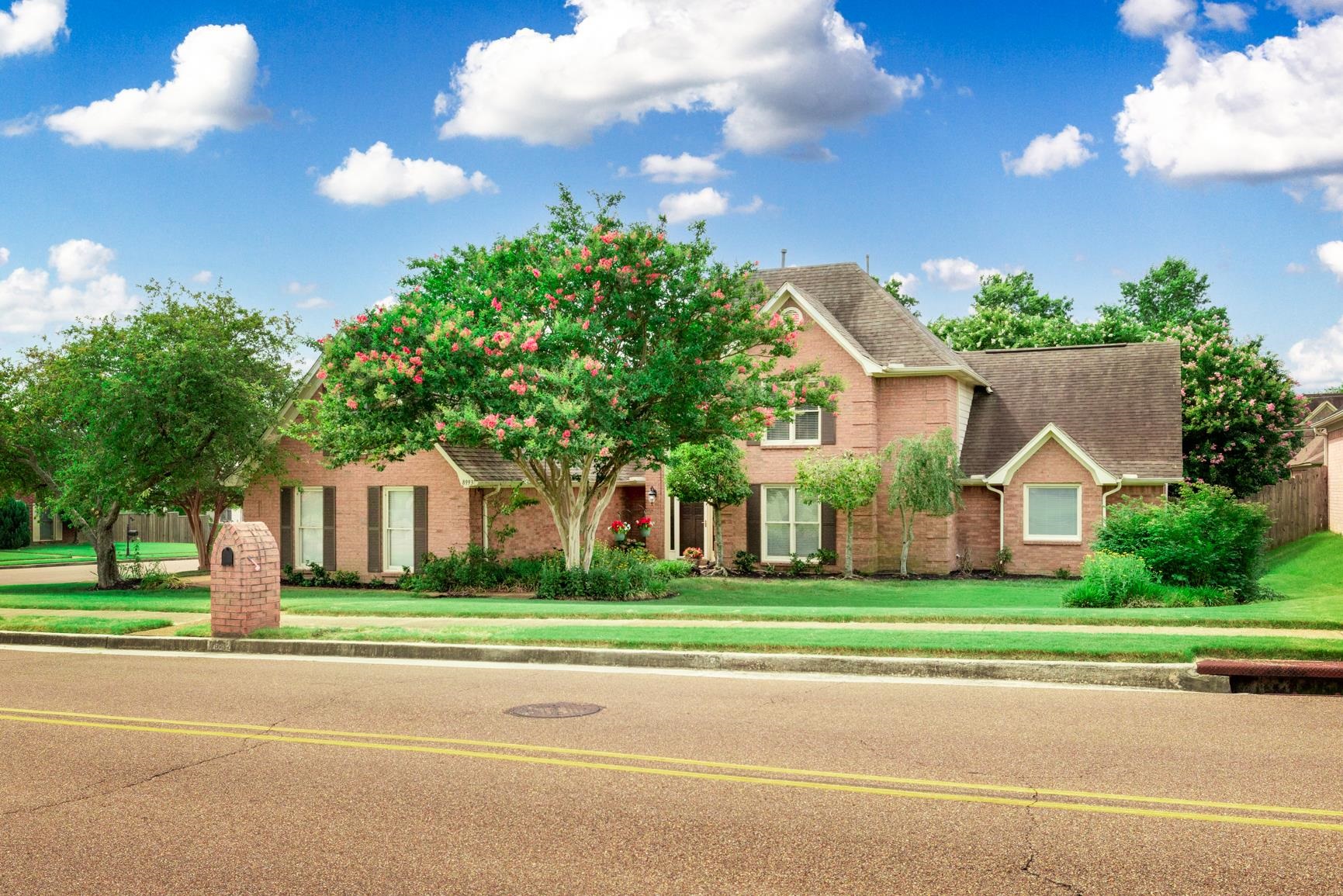 8993 Raspberry Lane Cordova, TN 38016 - Photo 1 of 40 a front view of a house with a yard and trees