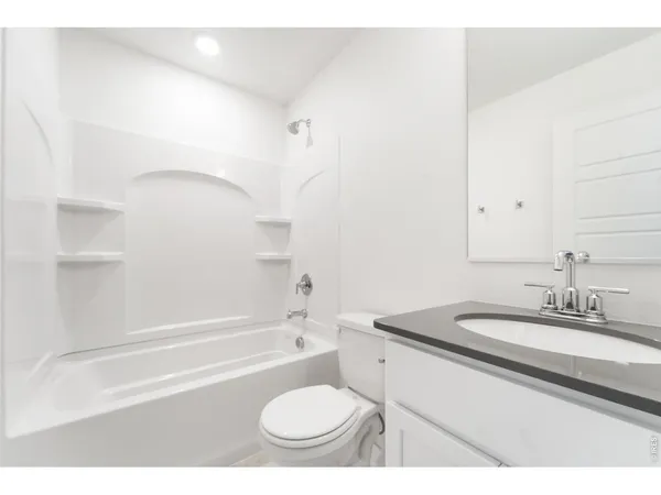 a bathroom with a sink toilet a mirror and shower