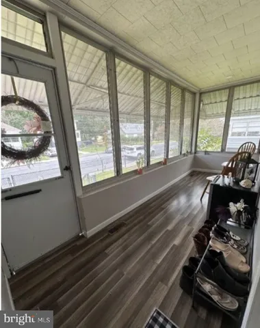 a room with wooden floor and furniture