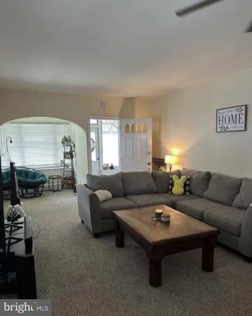 a living room with furniture and white walls