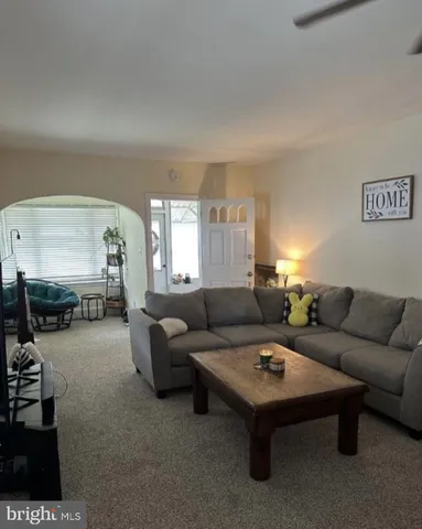 a living room with furniture and white walls