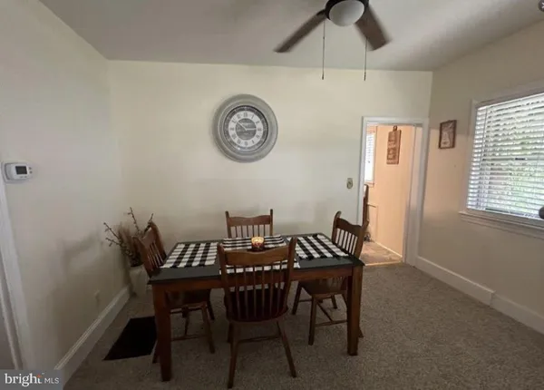 a view of a dining room with furniture and a window