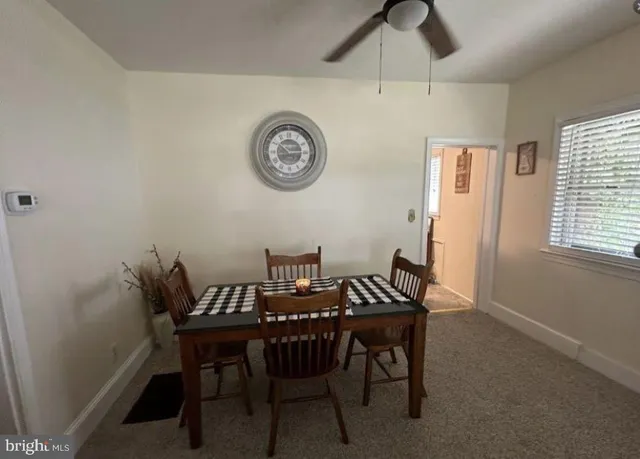 a view of a dining room with furniture and a window