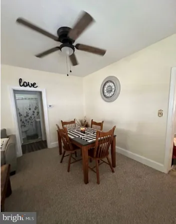 a view of a livingroom with furniture and a fan