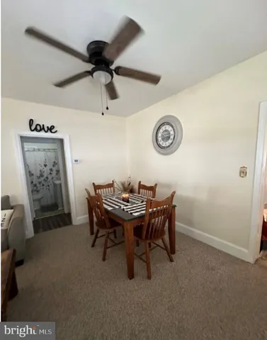 a view of a livingroom with furniture and a fan