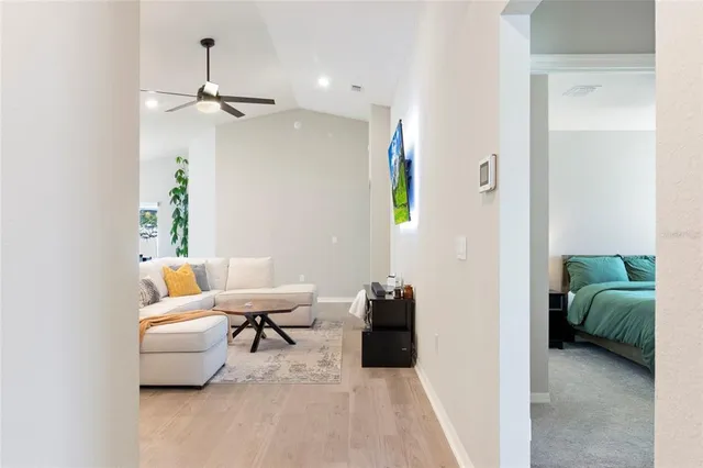 a living room with furniture and a potted plant