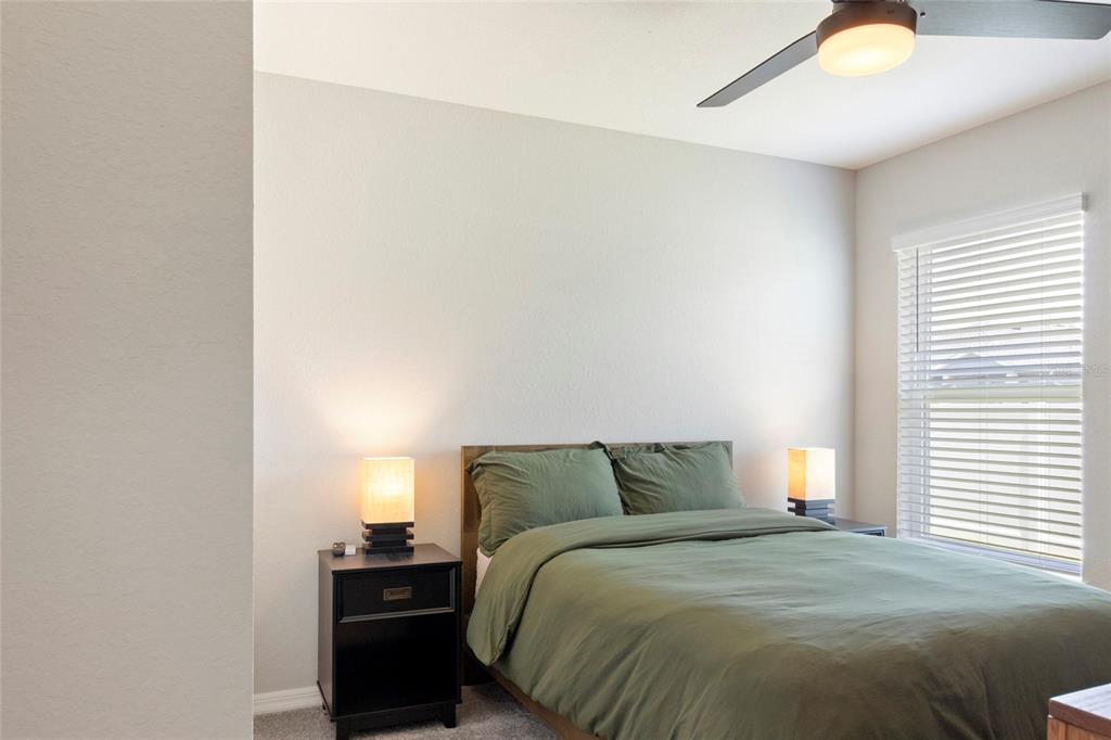 1204 Mezzavalle Way Auburndale, FL 33823 - Photo 15 of 42 a bedroom with a bed and a night stand