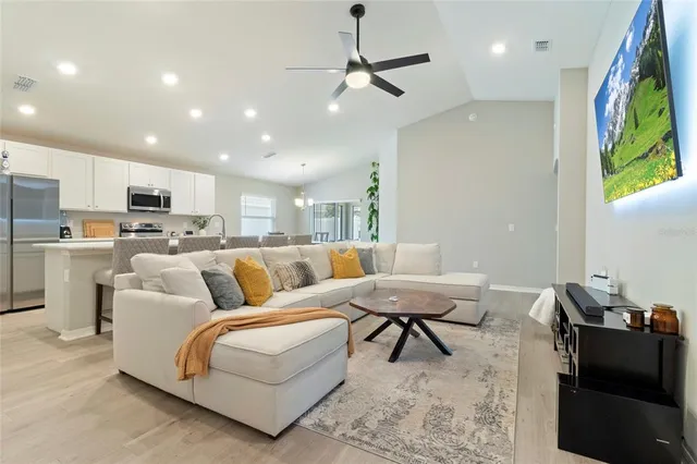 a living room with furniture and kitchen view