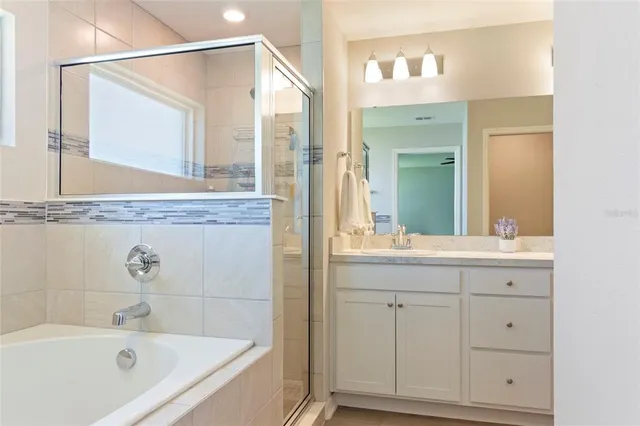 a bathroom with a granite countertop sink a shower and a mirror