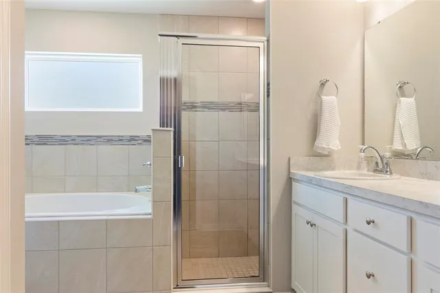 a view of a walk in closet and a bathroom