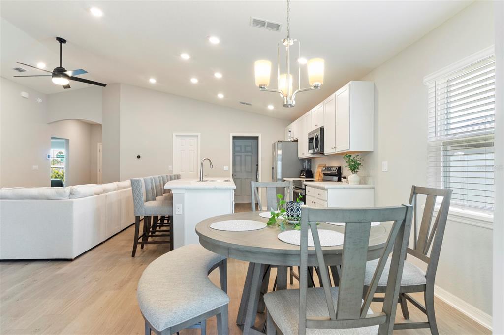 1204 Mezzavalle Way Auburndale, FL 33823 - Photo 26 of 42 a view of a dining room with furniture and a chandelier