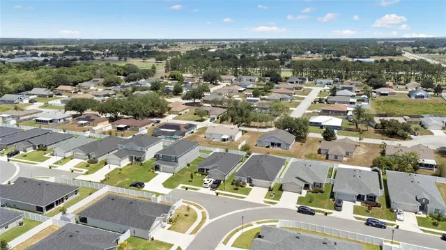 an aerial view of houses with yard