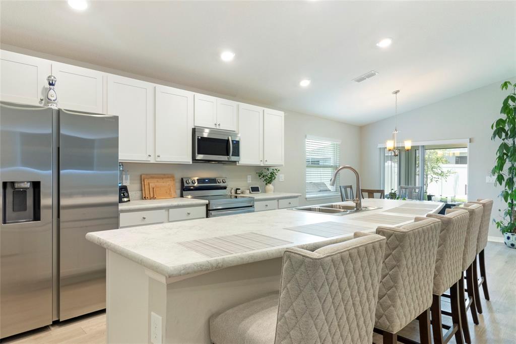 1204 Mezzavalle Way Auburndale, FL 33823 - Photo 4 of 42 a kitchen with sink a microwave and refrigerator