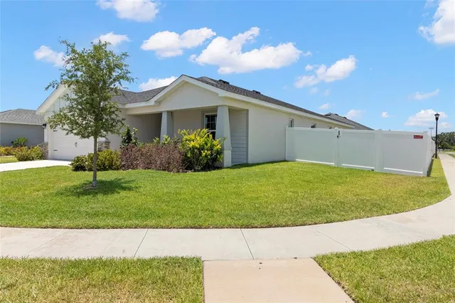 a front view of a house with a garden and yard
