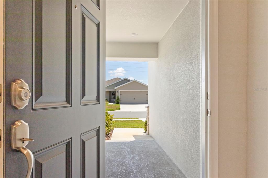 1204 Mezzavalle Way Auburndale, FL 33823 - Photo 8 of 42 a view of a bedroom from a corridor
