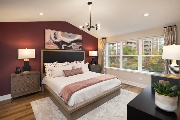 a bedroom with a large bed and a window