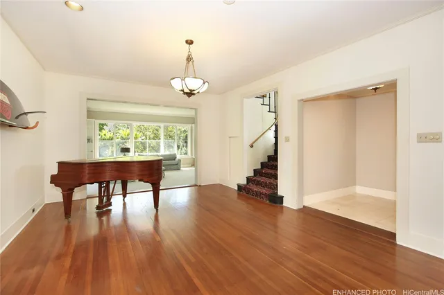 a view of a room with wooden floor table and chairs