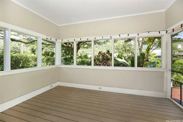 a view of wooden floor and windows in a room